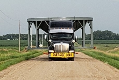 Oversize load transport front view on rural road